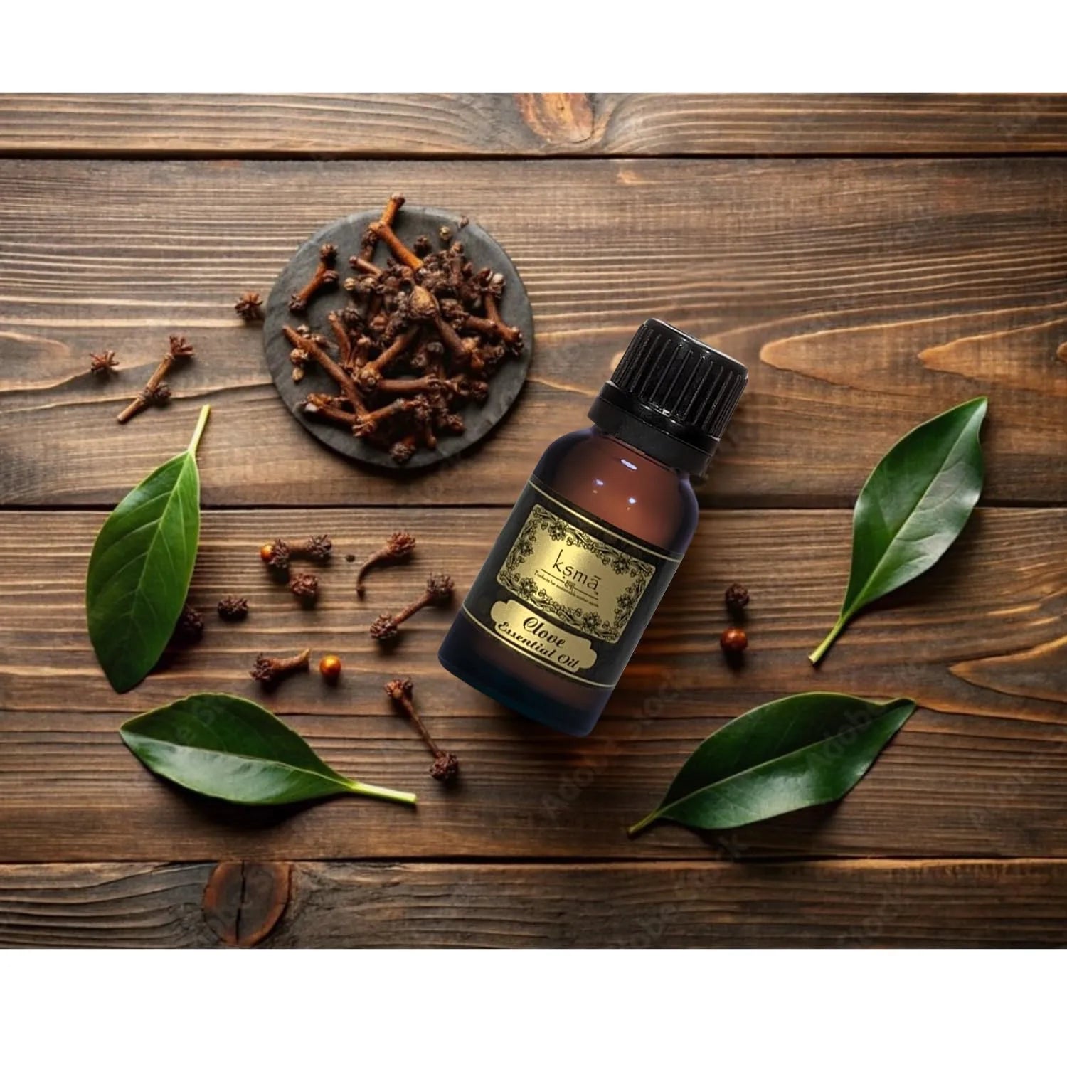 Clove essential oil bottle placed with dried cloves on wooden surface